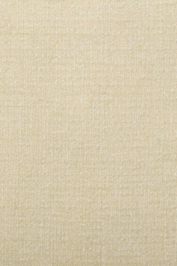a close up of a beige fabric textured background