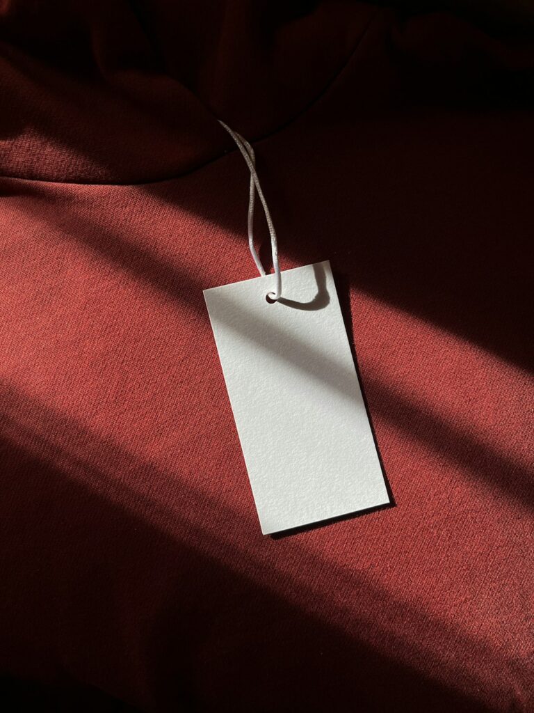 a red cloth with a white tag hanging from it