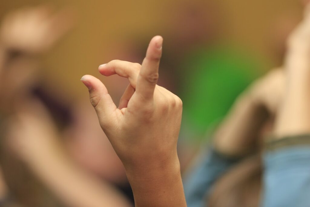 A group of people with their hands in the air