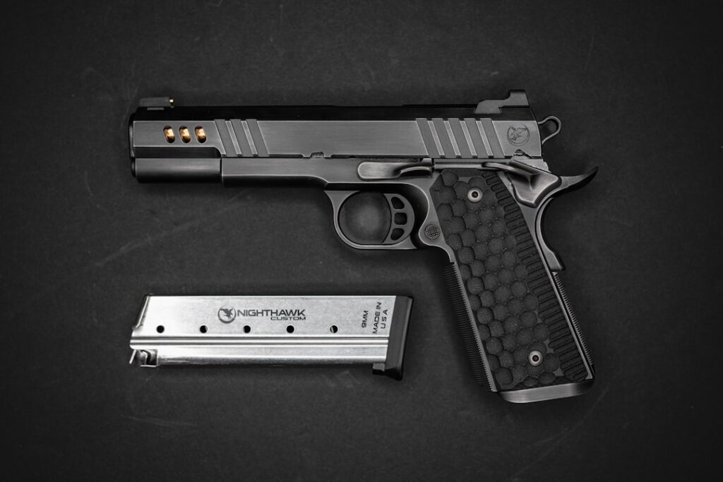 A black semi-automatic pistol with a textured grip and a metal magazine