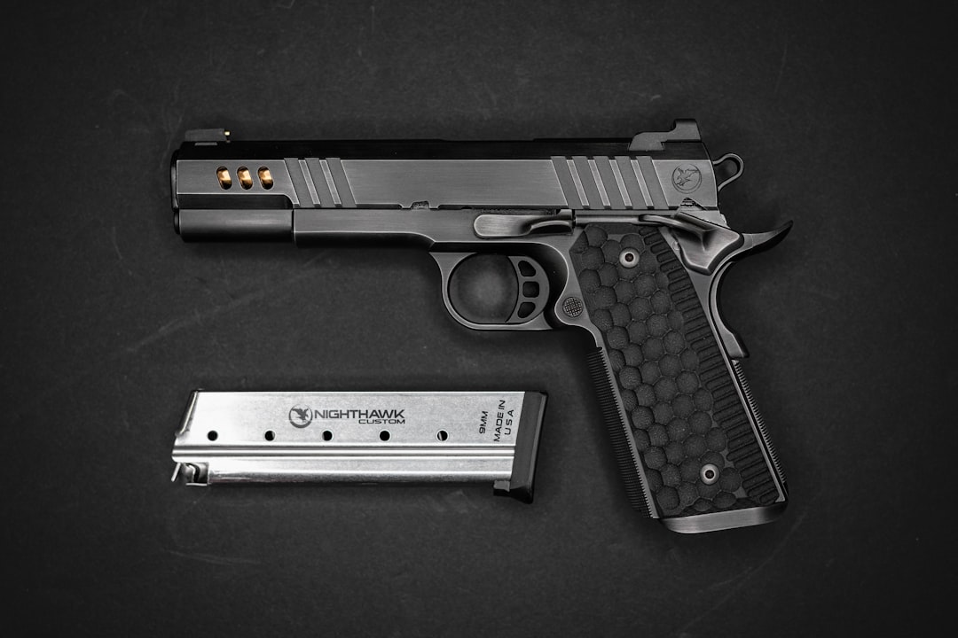 A black semi-automatic pistol with a textured grip and a metal magazine