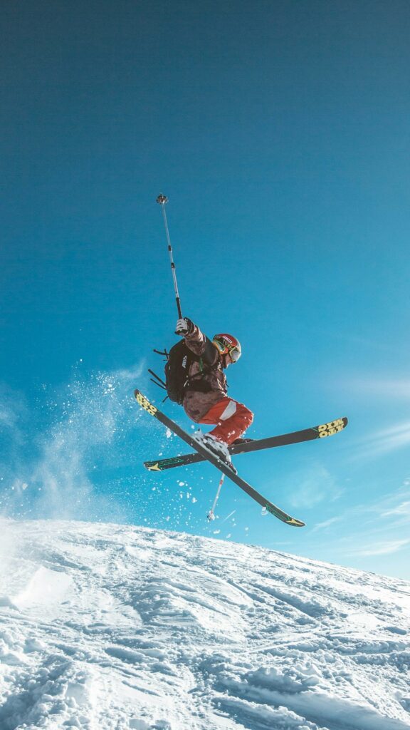 skier jumping over snowy slope