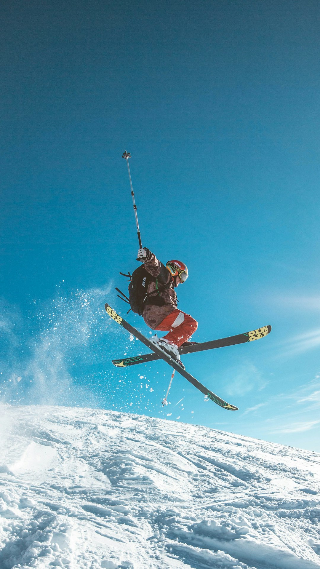 skier jumping over snowy slope