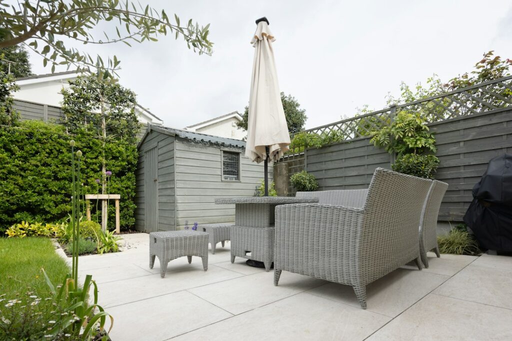 A patio with a table and chairs and an umbrella